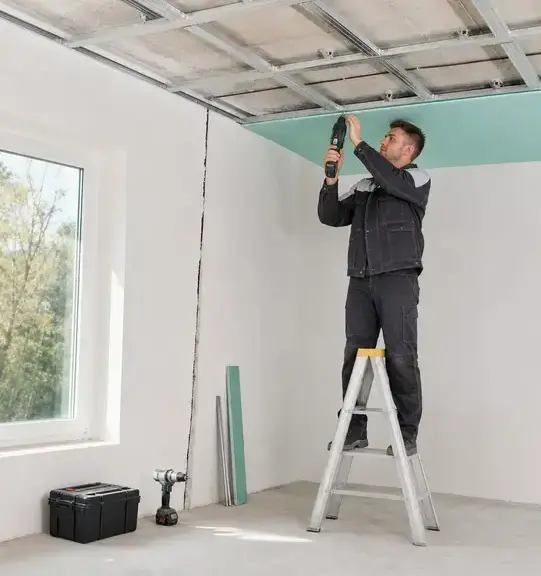 Worker installing a new drywall ceiling panel during ceiling water damage repair in Kaukauna, WI